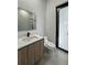 Bathroom features a wood vanity, white countertop, and a glass-enclosed shower in the background at 14520 Edna Cir, Port Charlotte, FL 33981
