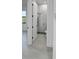 A modern bathroom featuring a glass shower with marbled walls and gray flooring at 14520 Edna Cir, Port Charlotte, FL 33981
