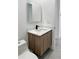 Close-up of a bathroom featuring a floating vanity with gray-wood cabinets at 14520 Edna Cir, Port Charlotte, FL 33981