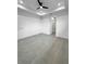 Large open bedroom with light gray flooring, modern ceiling fan and recessed lighting at 14520 Edna Cir, Port Charlotte, FL 33981