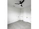 This bedroom has three doors, gray tile flooring, and a modern ceiling fan at 14520 Edna Cir, Port Charlotte, FL 33981