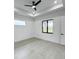 Bright bedroom featuring a large window and light gray flooring at 14520 Edna Cir, Port Charlotte, FL 33981