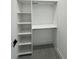 An organized walk-in closet features open shelving and a clothing rod at 14520 Edna Cir, Port Charlotte, FL 33981