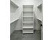 Walk-in closet featuring built-in shelving, providing ample storage space at 14520 Edna Cir, Port Charlotte, FL 33981