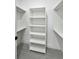 Walk-in closet featuring built-in shelving, providing ample storage space at 14520 Edna Cir, Port Charlotte, FL 33981