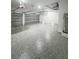 Large epoxy-floored three car garage with multiple garage door openers and a water heater at 14520 Edna Cir, Port Charlotte, FL 33981