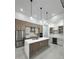 Well-equipped kitchen features stainless steel appliances, island, and built-in wine cooler at 14520 Edna Cir, Port Charlotte, FL 33981
