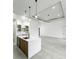 Open-concept living area with kitchen island, modern lighting, and abundant natural light at 14520 Edna Cir, Port Charlotte, FL 33981