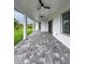 Large patio with a gray brick surface, and two ceiling fans, ideal for outdoor relaxation and gatherings at 14520 Edna Cir, Port Charlotte, FL 33981
