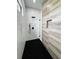 Luxurious shower featuring marble and wood-style tile accents, a sleek, black shower system and glass enclosure at 14520 Edna Cir, Port Charlotte, FL 33981