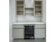 Convenient wet bar with wine cooler, cabinets, and quartz countertop at 14520 Edna Cir, Port Charlotte, FL 33981