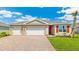 Charming single-story home with a three-car garage, paver driveway, and well-manicured lawn at 1472 Mableton Dr, Port Charlotte, FL 33953