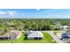 Aerial view of a home with a metal roof in a lush, green neighborhood at 15117 Lyneburg Ave, Port Charlotte, FL 33981