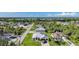 Stunning aerial view featuring the home with a metal roof in a quiet neighborhood at 15117 Lyneburg Ave, Port Charlotte, FL 33981