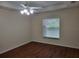 Bright bedroom features a ceiling fan and a window for natural light at 15117 Lyneburg Ave, Port Charlotte, FL 33981