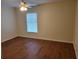 This bedroom features hardwood floors and a ceiling fan at 15117 Lyneburg Ave, Port Charlotte, FL 33981