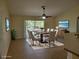 Staged dining area with seating for eight and a view of the backyard at 15117 Lyneburg Ave, Port Charlotte, FL 33981