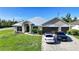 Charming single-story home with a well-maintained lawn and a three-car garage at 15117 Lyneburg Ave, Port Charlotte, FL 33981