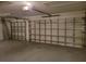Spacious garage with white doors and ample room for vehicles and storage at 15117 Lyneburg Ave, Port Charlotte, FL 33981