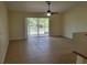 Bright living area with tile flooring and sliding glass doors to the outdoors at 15117 Lyneburg Ave, Port Charlotte, FL 33981