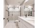 Modern bathroom features a double sink vanity, white countertops, and a glass enclosed shower at 16403 Perdida Ct, Punta Gorda, FL 33955