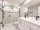 Modern bathroom features a double sink vanity, white countertops, and a glass enclosed shower at 16403 Perdida Ct, Punta Gorda, FL 33955