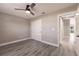 This bedroom features gray walls, wood-look flooring, a closet, and a ceiling fan at 16403 Perdida Ct, Punta Gorda, FL 33955