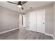 This bedroom features gray walls, wood-look flooring, a closet, and a ceiling fan at 16403 Perdida Ct, Punta Gorda, FL 33955