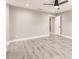 Spacious bedroom features gray wood floors, ceiling fan, and an attached bathroom at 16403 Perdida Ct, Punta Gorda, FL 33955