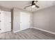 This bedroom features gray walls, wood-look flooring, a closet, and a ceiling fan at 16403 Perdida Ct, Punta Gorda, FL 33955