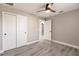 Bedroom featuring gray walls, closet, wood-look flooring, and modern ceiling fan at 16403 Perdida Ct, Punta Gorda, FL 33955