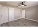 This bedroom features gray walls, wood-look flooring, a closet, and a ceiling fan at 16403 Perdida Ct, Punta Gorda, FL 33955