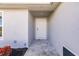 View of front entrance to home with covered porch and gray siding at 16403 Perdida Ct, Punta Gorda, FL 33955