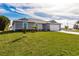 Charming gray single-story home with a well-manicured lawn and lovely landscaping at 16403 Perdida Ct, Punta Gorda, FL 33955