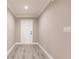 Inviting hallway featuring modern gray wood-look floors and neutral-toned walls with white trim and a front door at 16403 Perdida Ct, Punta Gorda, FL 33955