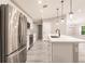 Spacious kitchen features stainless appliances, an island with a sink, and plank flooring at 16403 Perdida Ct, Punta Gorda, FL 33955