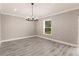 Bright living room featuring hardwood floors and large window at 16403 Perdida Ct, Punta Gorda, FL 33955