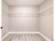 Bright walk-in closet featuring wire shelving, modern gray walls, and light wood-look flooring at 16403 Perdida Ct, Punta Gorda, FL 33955
