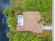 An overhead aerial view reveals a private pool, lush landscaping, and water access at 17125 Canary Ln, Port Charlotte, FL 33948