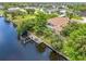 An aerial view of the home on the water showing the private dock and serene canal setting at 17125 Canary Ln, Port Charlotte, FL 33948
