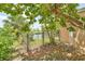 The backyard features a water view, lush green landscaping and a gate at 17125 Canary Ln, Port Charlotte, FL 33948