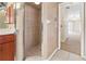 Ensuite bathroom features a tiled shower with glass door and a linen closet at 17125 Canary Ln, Port Charlotte, FL 33948