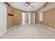 Spacious bedroom featuring neutral carpet, a ceiling fan, and a large walk in closet for plenty of storage space at 17125 Canary Ln, Port Charlotte, FL 33948