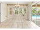 Bright dining area with bay windows and a sliding glass door that leads to the pool area at 17125 Canary Ln, Port Charlotte, FL 33948