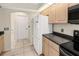 A kitchen area with bright lighting, updated appliances, and a view leading to other areas of the home at 17125 Canary Ln, Port Charlotte, FL 33948