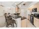 Kitchen with sleek black appliances, light wood cabinets, and barstool seating at the countertop at 17125 Canary Ln, Port Charlotte, FL 33948