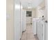 Functional laundry room with tile floors, washer, dryer, plenty of cabinet space, and a window for natural light at 17125 Canary Ln, Port Charlotte, FL 33948