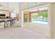 Bright living room boasts a bar and sliding glass doors that opens to the screened lanai and pool at 17125 Canary Ln, Port Charlotte, FL 33948