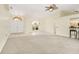 Spacious living room featuring tile and carpet flooring, open layout, and arched doorways at 17125 Canary Ln, Port Charlotte, FL 33948