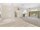 Bright and airy living room featuring tile and carpet flooring, with access to the outdoor pool area at 17125 Canary Ln, Port Charlotte, FL 33948